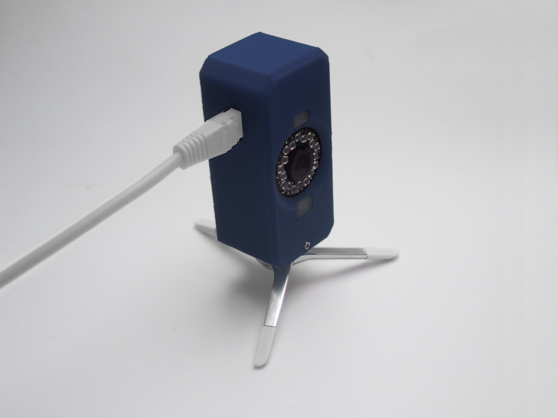 Prototype Tracking Camera with a CAT cable plugged in on a small tripod